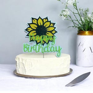 Adorno para tarta de feliz cumpleaños con forma de girasol.