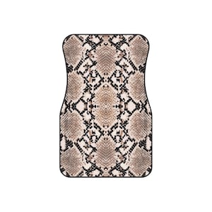 May include: A car floor mat with a snakeskin pattern. The mat has a repeating design of tan, brown, and black scales, with a black border. The shape is designed to fit the driver's side of a vehicle.