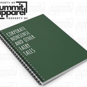 May include: A dark green spiral-bound notebook with the text "CORPORATE NONSENSE AND OTHER FAIRY TALES" in white. The notebook is from Summit Apparel. The cover is a solid, deep green colour.