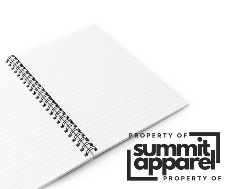 May include: A white, lined notebook with a black spiral binding. The pages are ruled with horizontal lines. The notebook features the text "PROPERTY OF" above and below the black and white "Summit Apparel" logo.