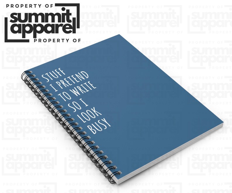 May include: A blue notebook with a black spiral binding. The white text on the cover reads "STUFF I PRETEND TO WRITE SO I LOOK BUSY." The logo "summit apparel" is in the upper left corner.