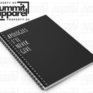 May include: Black spiral-bound notebook with the text "APOLOGIES I'LL NEVER GIVE" in white. The notebook has a black cover and white pages. The Summit Apparel logo is in the top left corner.