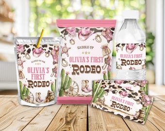 May include: A set of party supplies with a Western theme, including a juice pouch, a bag of crisps, a water bottle, and a chocolate bar wrapper. Each item features a pink and brown cow print design with cowboy hats, boots, and the text "Olivia's First Rodeo."