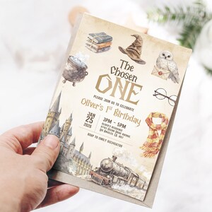 May include: A birthday invitation with a watercolor design featuring a castle, a train, and other magical elements. The text reads "The Chosen One" and invites guests to Oliver's 1st Birthday.