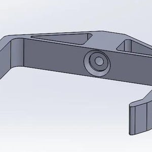 May include: A gray plastic hook with a triangular shape and a round hole in the center.