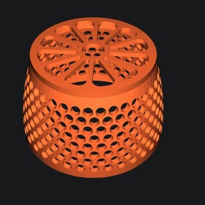 Peut inclure: Objet cylindrique orange avec un design perforé. Le dessus présente un motif radial, tandis que les côtés sont recouverts de trous circulaires espacés. L'objet est posé sur un fond sombre, soulignant sa structure géométrique unique.