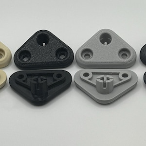 May include: Eight triangular plastic components in various colors: beige, black, and gray. Each piece has a hole and two smaller holes. The bottom pieces have a cross-shaped design.