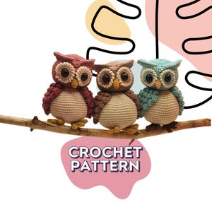 May include: Three crocheted owl figures perched on a wooden branch. The owls are pink, brown, and light blue, each featuring large dark eyes, cream-colored bellies, and yellow beaks. The text CROCHET PATTERN is displayed in a pink graphic shape.