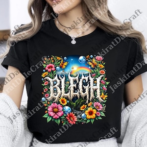 Puede incluir: Camiseta negra con un diseño floral y la palabra "BLEGH" en una fuente estilizada. El diseño incluye un arcoíris, mariposas y flores coloridas. La camiseta es de cuello redondo.