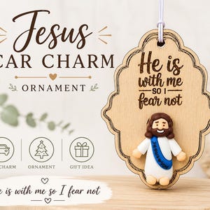 May include: Wooden car charm with a decorative border, featuring a small Jesus figurine and the text "He is with me so I fear not." The charm is designed as an ornament and gift idea.