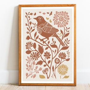 May include: A framed print depicting a brown bird perched on a branch with pink and gold flowers. The bird is surrounded by leaves and branches, creating a floral design.