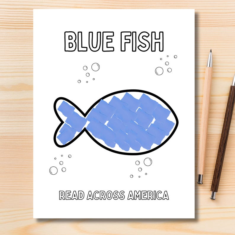 May include: A white sheet of paper with the words "BLUE FISH" at the top and "READ ACROSS AMERICA" at the bottom. A blue fish illustration is in the centre, with bubbles around it. Two pencils are on the right side of the paper.