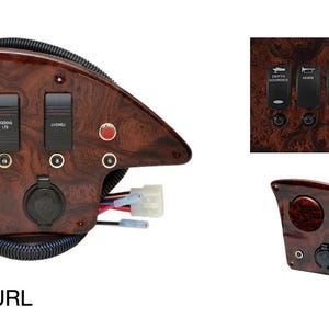 Puede incluir: Un panel de madera de grano marr&oacute;n con tres interruptores de palanca, un bot&oacute;n rojo y una toma de corriente. El panel est&aacute; etiquetado como "REGAL BURL".