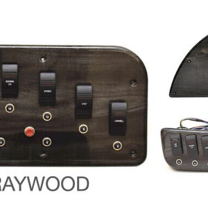 Puede incluir: Un panel de interruptores de madera gris con ocho interruptores de palanca y un bot&oacute;n rojo. El panel tiene un acabado de madera y est&aacute; etiquetado como "GRAYWOOD".