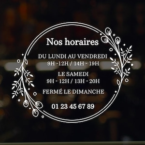 Peut inclure: Une pancarte blanche avec une bordure florale et le texte "Nos horaires" dans un cercle. La pancarte indique les heures d'ouverture : du lundi au vendredi de 9h à 12h et de 14h à 19h, le samedi de 9h à 12h et de 13h à 20h, et fermé le dimanche. Le numéro de téléphone 01 23 45 67 89 est également indiqué.