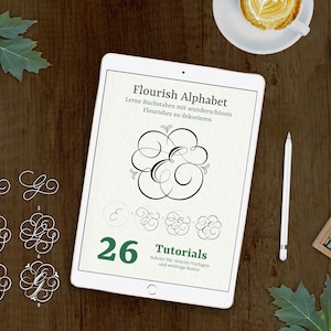 May include: A digital tablet displaying a guide to calligraphy with the title "Flourish Alphabet". The guide includes 26 tutorials on how to create beautiful flourishes with lettering. The tablet is on a wooden surface with a cup of coffee, a pencil, and a leaf.
