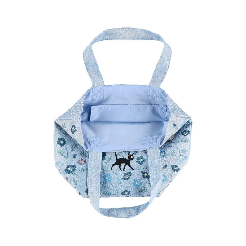 May include: A light blue tote bag with a black cat and floral design. The bag has two handles and a spacious interior.