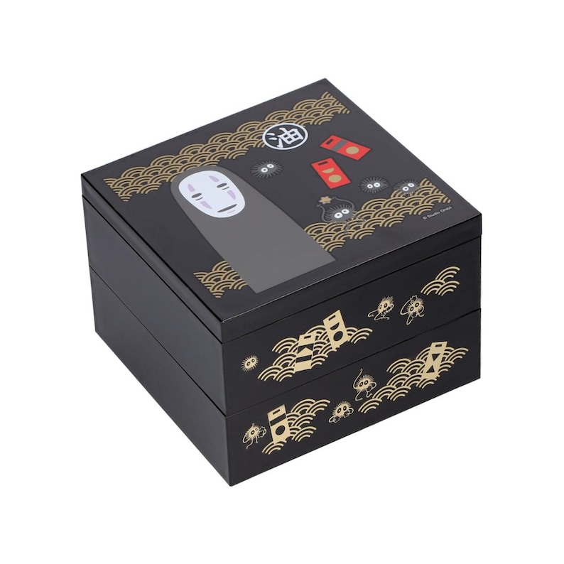 May include: Black, two-tiered box featuring a design from the animated film Spirited Away. The top of the box has an illustration of No-Face and other characters. Gold wave patterns and Japanese text decorate the box.