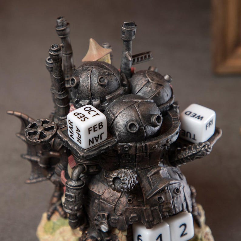 May include: A detailed steampunk-style perpetual calendar sculpture in shades of gray and brown. The sculpture features multiple dice displaying months and days, along with numbered dice. The design includes mechanical-looking components and a small, tan-colored structure.