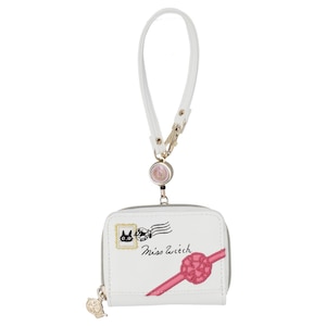 May include: White wallet with a wrist strap, featuring a zipper closure and a decorative charm. The wallet has a design of a black cat, a pink ribbon, and the text "Miss Witch". The wrist strap is white with a gold-colored clasp.