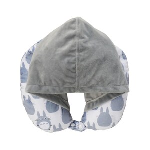 May include: A gray travel pillow with a hood. The hood and the top of the pillow are a solid gray color. The bottom of the pillow is white with a pattern of blue cartoon characters. The pillow has a snap closure.