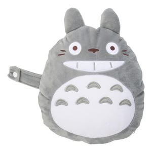 May include: A gray plush Totoro character with a white belly, large eyes, and a wide smile. The plush has small ears and a strap with a button. The design is based on the animated film My Neighbor Totoro.