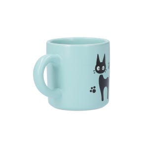 May include: A light blue ceramic mug featuring a black graphic illustration of a cat with large eyes and pointed ears. The design includes small black paw prints surrounding the cat figure, set against the solid pastel blue surface of the mug.