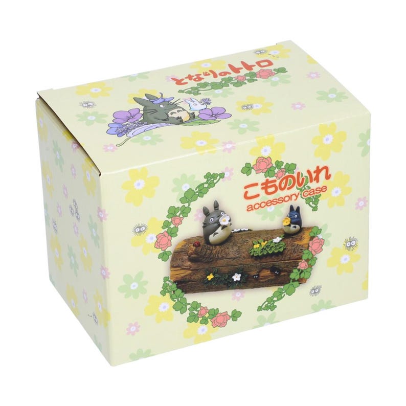 May include: A decorative accessory case featuring characters from the animated film "My Neighbor Totoro." The box is light yellow with a floral pattern. The front of the box has a wooden log with Totoro and other characters.