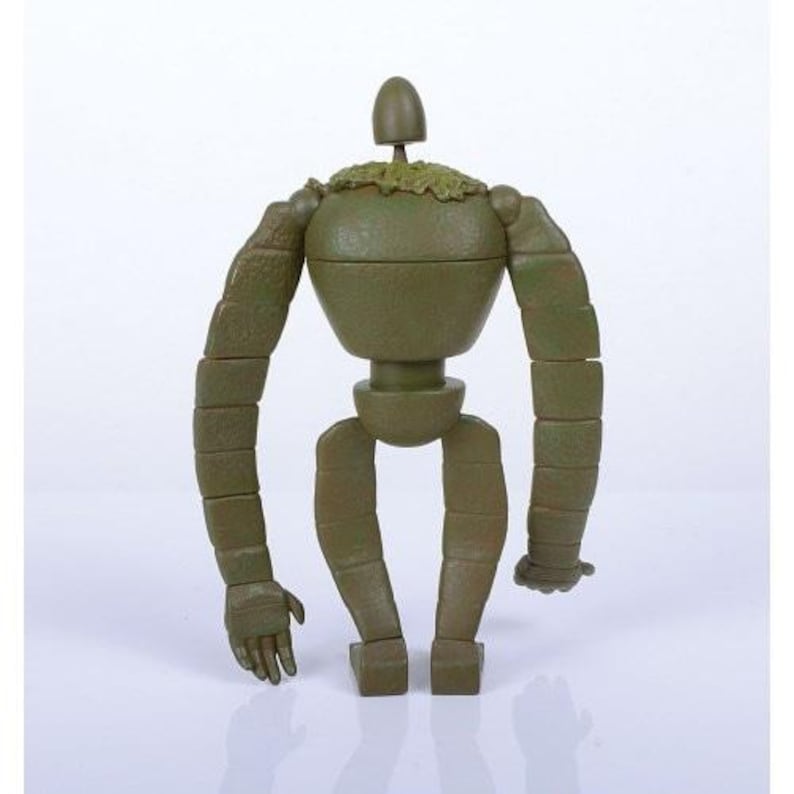Peut inclure: Une figurine de robot vert avec des membres segment&eacute;s et un corps arrondi. La figurine a une petite t&ecirc;te et un morceau de mati&egrave;re verte sur les &eacute;paules. Les bras du robot sont tendus et ses mains sont l&eacute;g&egrave;rement courb&eacute;es.