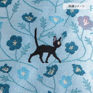 May include: A light blue fabric with a repeating pattern of blue flowers and vines. A black cat is embroidered on the fabric, walking among the flowers. The text "Embroidery Image" is in the upper right corner.