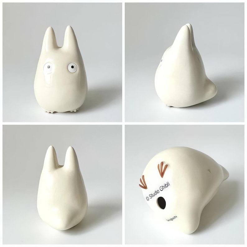 May include: A set of four images showcasing a cream-colored ceramic figurine. The figurine has a rounded body, two tall ears, and small, detailed facial features. The bottom of the figurine has the text "Studio Ghibli".