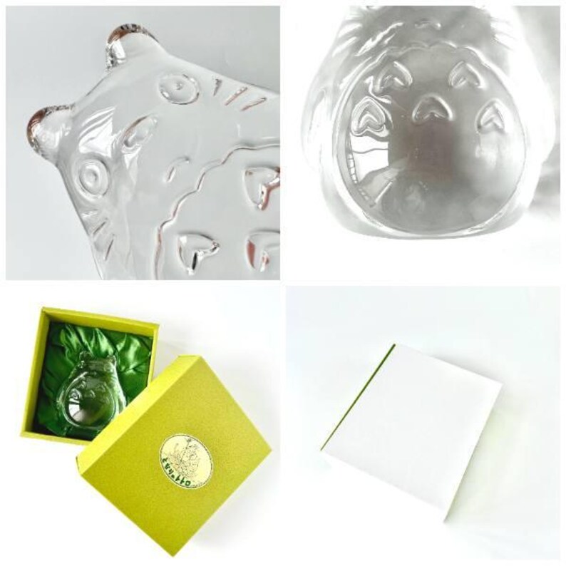 May include: Clear glass Totoro-shaped bottle with embossed details. The bottle is presented in a yellow gift box with a green satin lining. The box has a gold emblem. A white card is also included.