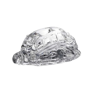 May include: A clear glass turtle figurine with detailed shell and head. The figurine is made of transparent glass, showcasing the intricate design of the turtle's shell and body. The turtle is a decorative item.