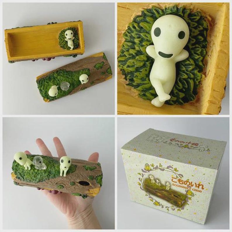Pode incluir: Uma cole&ccedil;&atilde;o de figuras decorativas e uma caixa com personagens de um filme de anima&ccedil;&atilde;o japon&ecirc;s. As figuras retratam pequenos esp&iacute;ritos da floresta brancos sobre uma base em forma de tronco com musgo verde. A caixa tem um design floral e texto japon&ecirc;s.