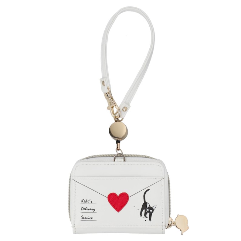 May include: White wallet with a zipper closure, a wrist strap, and a gold-colored charm. The wallet features a red heart, a black cat illustration, and the text "Kiki's Delivery Service."