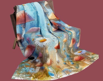 May include: A blue and white throw blanket with a watercolor design of mushrooms and daisies. The blanket is draped over a chair.