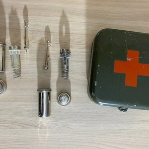 Russian military first aid kit with glass syringes.