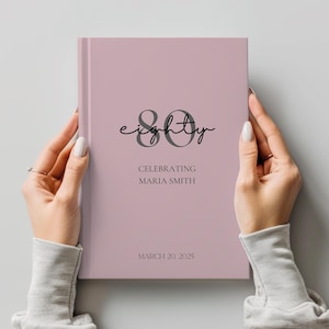 May include: A pink journal with the number "80" and the word "eighty" in a script font. The text "Celebrating Maria Smith" and the date "March 20, 2025" are printed on the cover.