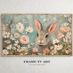 Könnte beinhalten: Gerahmtes Kunstwerk mit einem Hasen inmitten weißer und rosa Blumen. Der Hase hat graues Fell und lange Ohren mit rosa Innenseiten. Der Hintergrund ist ein sanftes Blau, mit dem Text "FRAME TV ART" und "UNIQFINDART" unten.
