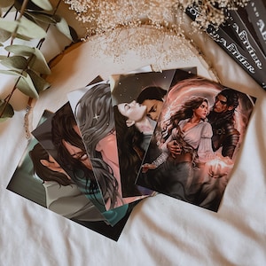 May include: A set of five illustrated cards featuring romantic scenes with couples. The cards are printed on white cardstock and have a matte finish.