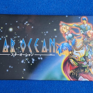 Może przedstawiać: Prostokątne pudełko z grą wideo Star Ocean z czarnym tłem i białymi gwiazdami. Tytuł Star Ocean jest wydrukowany niebiesko-białą czcionką z japońskimi znakami poniżej. Po prawej stronie znajdują się cztery ilustrowane postacie.