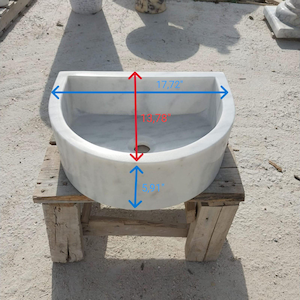 May include: A white marble sink with a rounded front and a rectangular top. The sink measures 45 cm wide, 35 cm high, and 15 cm deep. It is placed on a rustic wooden stand.