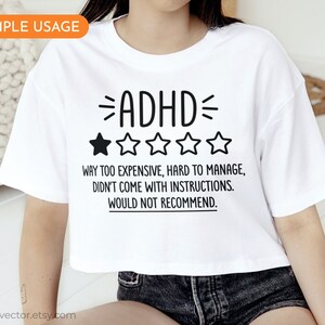 May include: White cropped t-shirt with black text that reads "ADHD" and a one-star rating. The text below the rating reads "Way too expensive, hard to manage, didn't come with instructions. Would not recommend."