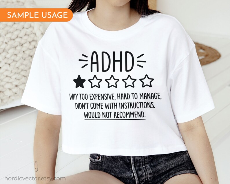 May include: White cropped t-shirt with black text that reads "ADHD" and a one-star rating. The text below the rating reads "Way too expensive, hard to manage, didn't come with instructions. Would not recommend."