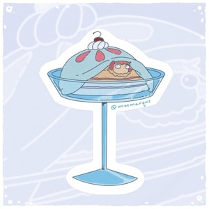 May include: A whimsical sticker featuring a cartoon illustration of a dessert. The dessert is covered with a light blue dome, decorated with pink spots and topped with whipped cream and a cherry. The dessert sits on a tall, clear glass stand.