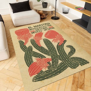 May include: A beige rug with a vintage design featuring red and green cactus plants. The text "EL MAESTRO REVISTA DCULTVRA NACIONAL MEXICO MCMXXI" is printed on the rug.