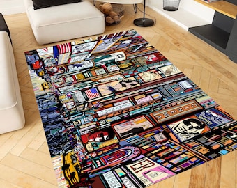 May include: A rectangular area rug featuring a vibrant, multi-colored graphic illustration of a busy city street scene at night. The design includes stylized depictions of illuminated billboards, neon signs, yellow taxis, and crowds of people.