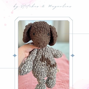 Könnte beinhalten: Gehäkeltes Welpenspielzeug mit dem Text "BAILEY THE GSP PUP" und "by. Stitches & Magnolias". Der Spielzeughund ist braun und weiß, mit einem braunen Kopf und Ohren. Der Körper ist eine Mischung aus weißem und schwarzem Garn.