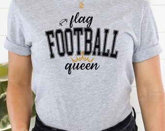 May include: A gray t-shirt with the text "flag FOOTBALL queen" and a crown graphic. The shirt is made of a soft, comfortable material.