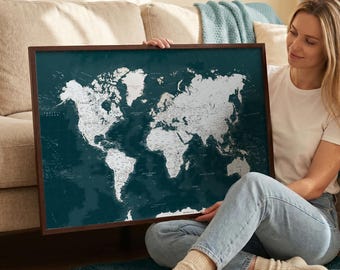 May include: A framed world map with a dark teal background and white landmasses. The map is encased in a dark brown wooden frame. The map is a decorative piece, suitable for home or office decor.